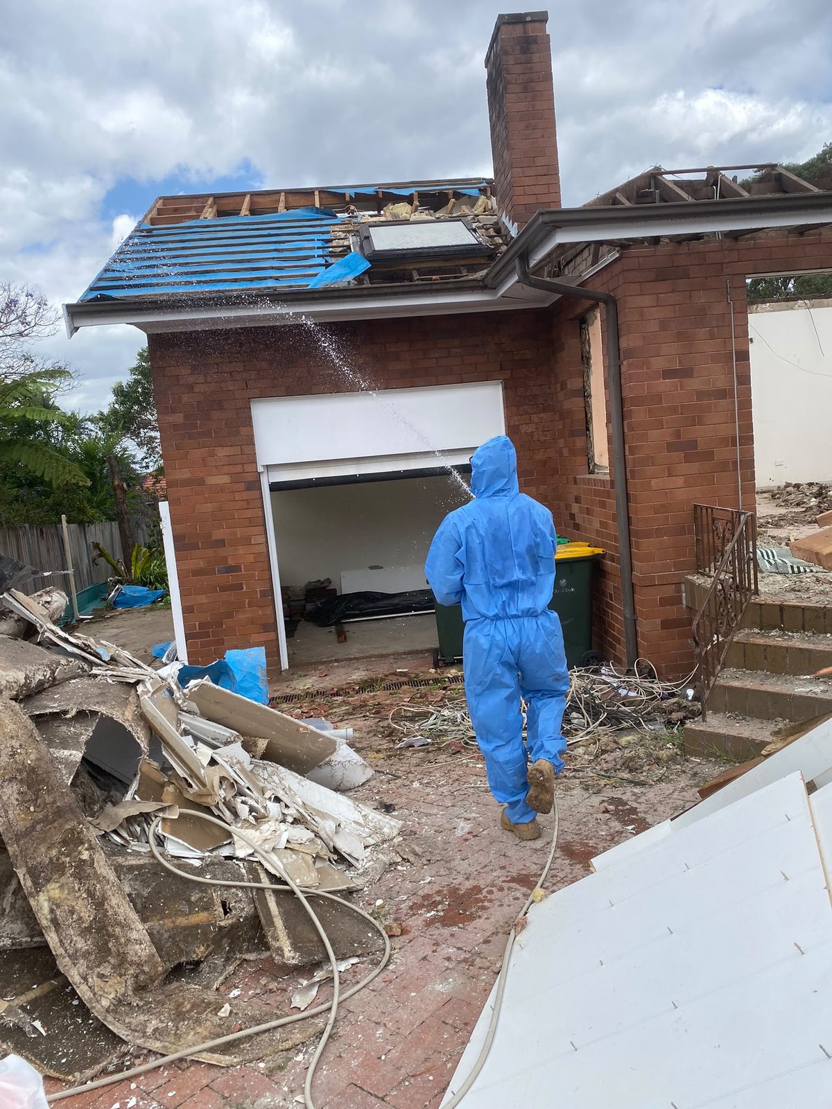 Worker in protective coveralls on a residential asbestos job