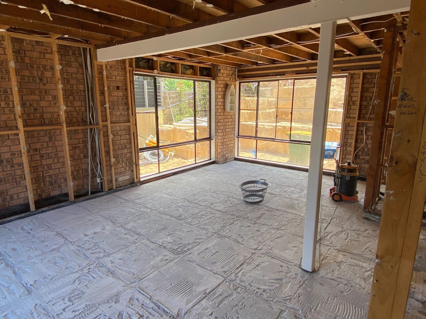 Open plan living area stripped back to frame and slab